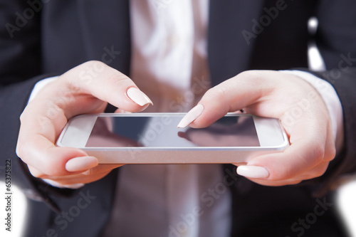 Fototapeta Naklejka Na Ścianę i Meble -  phone in female hands, white background