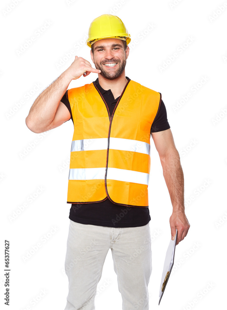 Smiling man in work clothes making a call me sign Smiling man in work clothes making a call me sign