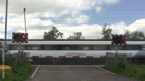 Diesel train crossing a level crossing.