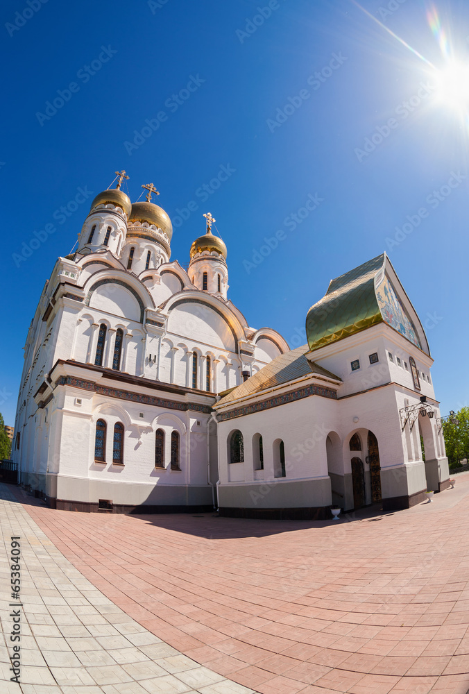 Russian orthodox church with gold domes against bright sunlight