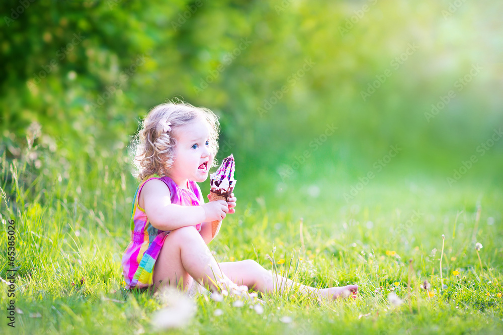 Funny girl eating ice cream in the garden Funny girl eating ice cream in the garden