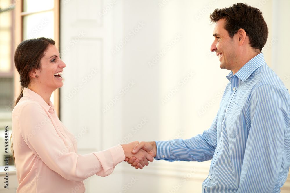 Male and female coworkers giving hands greeting Male and female coworkers giving hands greeting