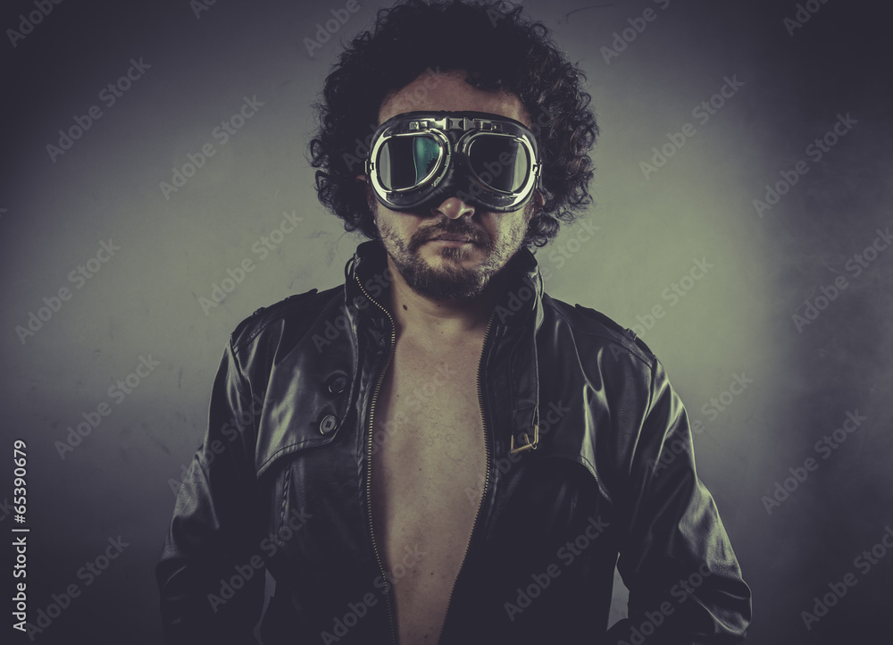 Freedom Biker, man with googles and black coat, smoke and dark b Freedom Biker, man with googles and black coat, smoke and dark b