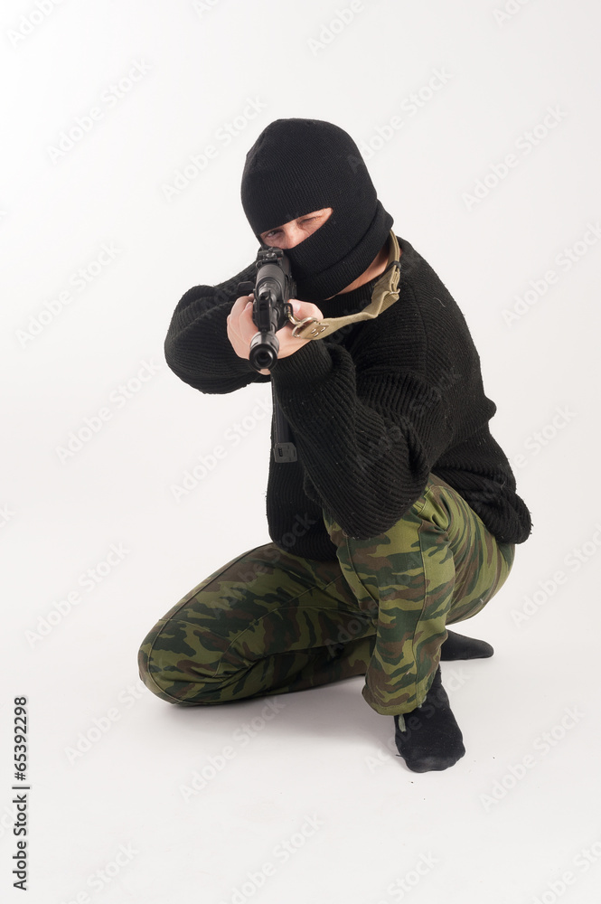 masked man aims with rifle