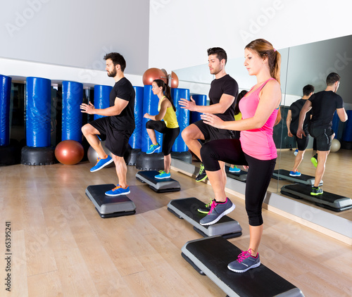 Cardio step dance group at fitness gym training