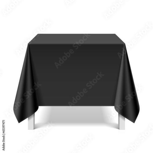 Square table covered with black tablecloth