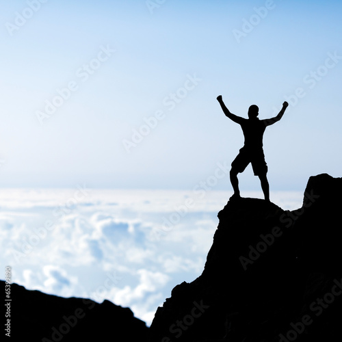 Success man silhouette, climbing in mountains