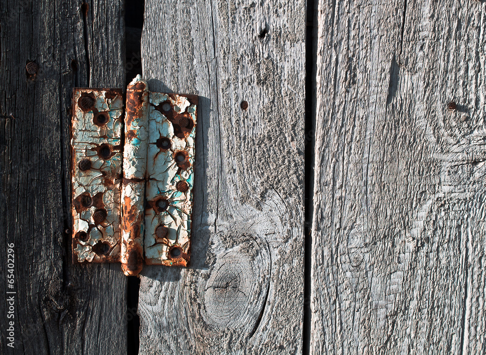 Old rusty metal door hinge on wooden door Old rusty metal door hinge on wooden door
