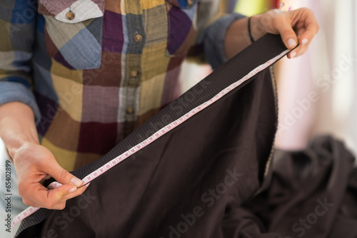 Closeup on seamstress measuring fabric