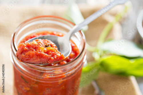 Fotografie Pizza sauce in a jar selective focus