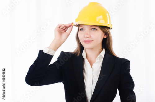 Pretty businesswoman with hard hat isolated on white