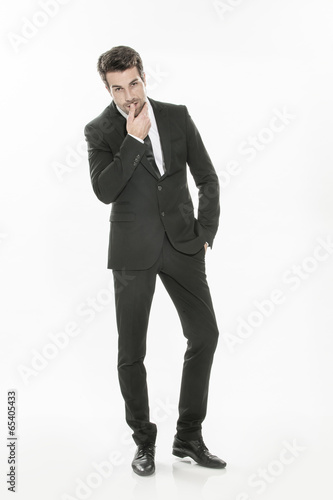 handsome young man in suit posing on isolated background