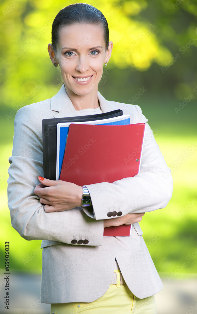Fototapeta premium Portrait of smiling business woman with paper folder. Student