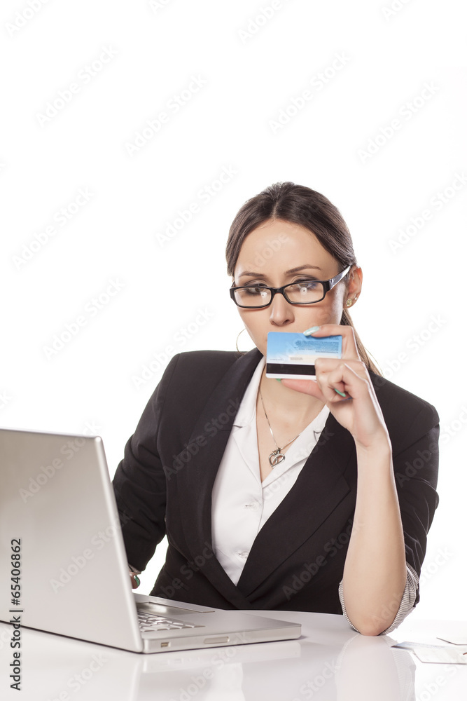 young woman carefully read the numbers from her credit card young woman carefully read the numbers from her credit card