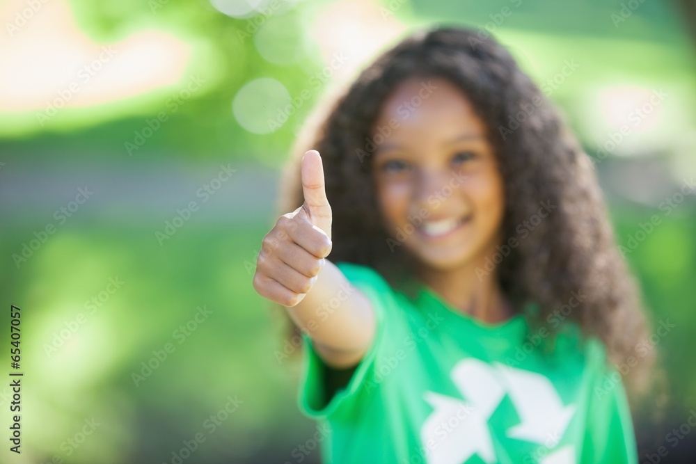 Young environmental activist smiling at the camera showing thumb Young environmental activist smiling at the camera showing thumb