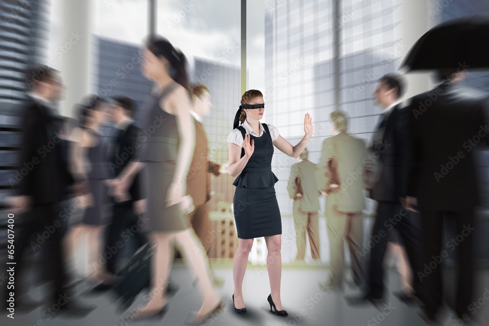 Composite image of redhead businesswoman in a blindfold Composite image of redhead businesswoman in a blindfold