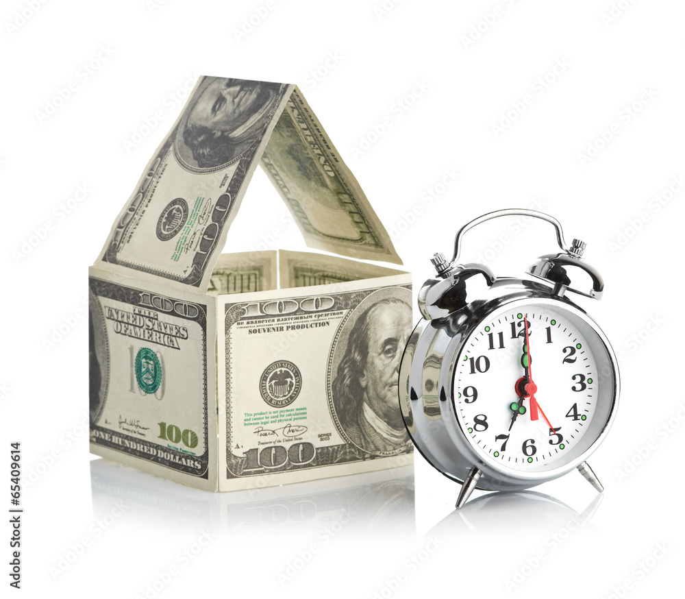 house made of dollars and alarm clock. house made of dollars and alarm clock.