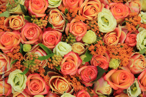 Orange and yellow roses in a bridal bouquet