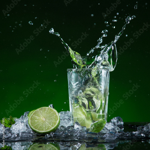 Fresh mojito cocktail in freeze motion splashing