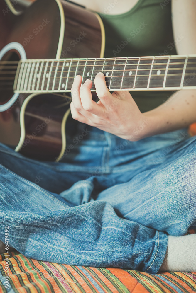 Fototapeta premium close up of woman hands playing guitar
