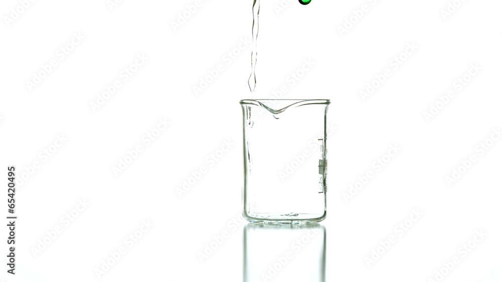 Green liquid pouring into beaker Green liquid pouring into beaker