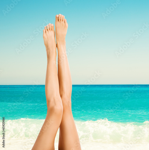 Beautiful female legs on the beach