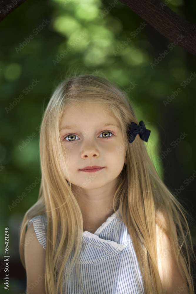 Naklejka premium Portrait of a beautiful blonde little girl three years