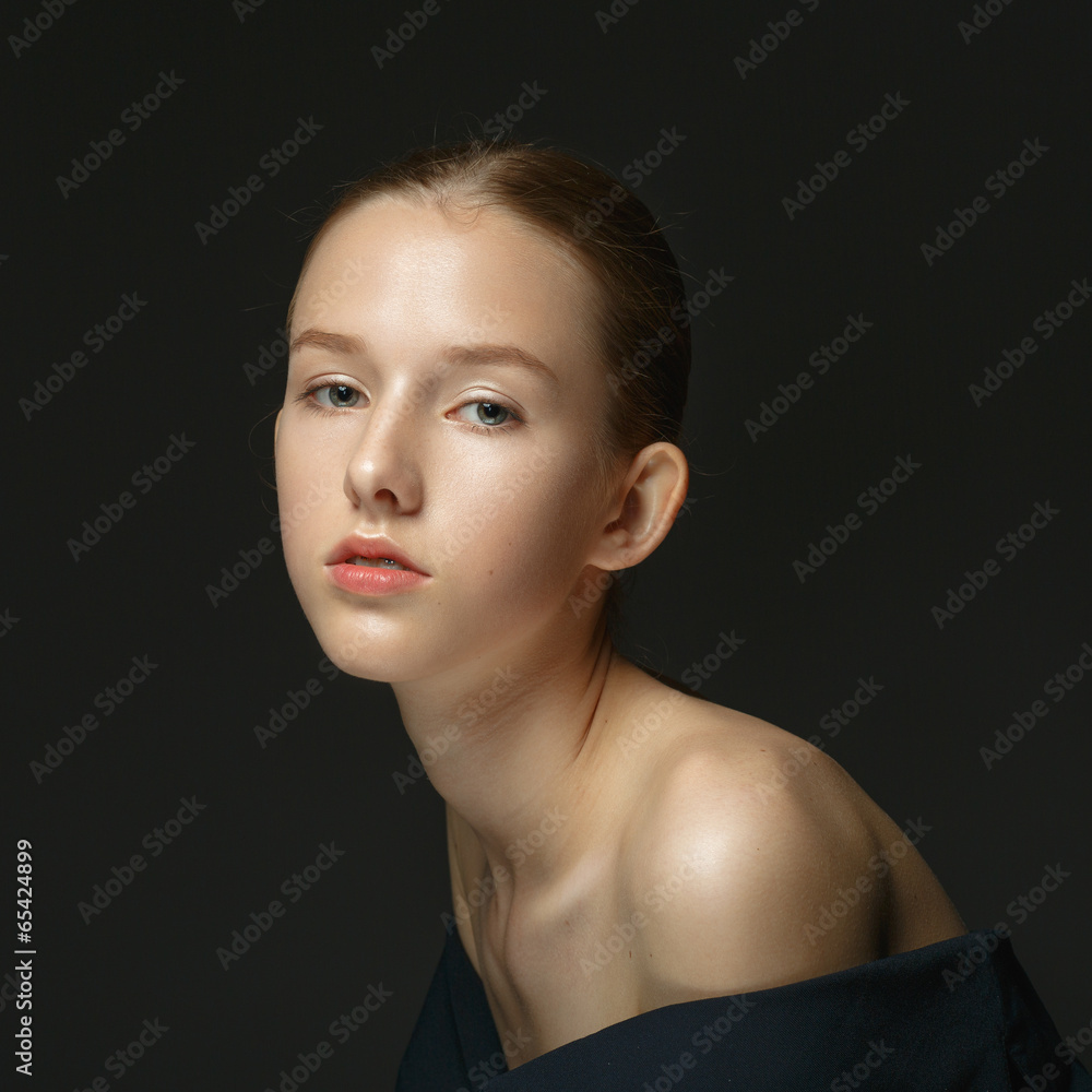 Portrait of a young girl on a dark background. Portrait of a young girl on a dark background.