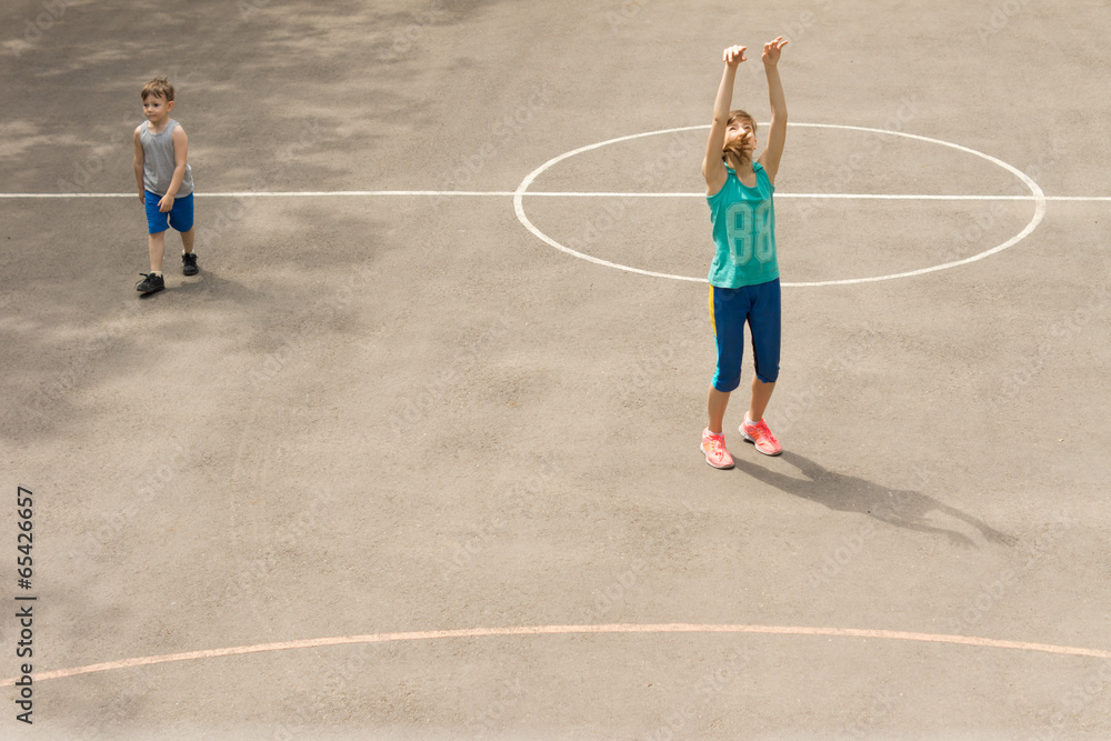 Young girl practising on a basketball court