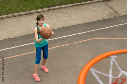 Young girl practising for the basketball team