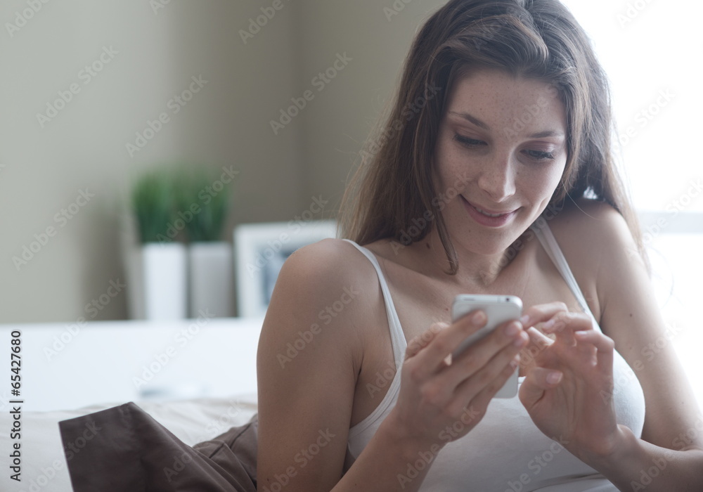 Woman relaxing on her bedroom