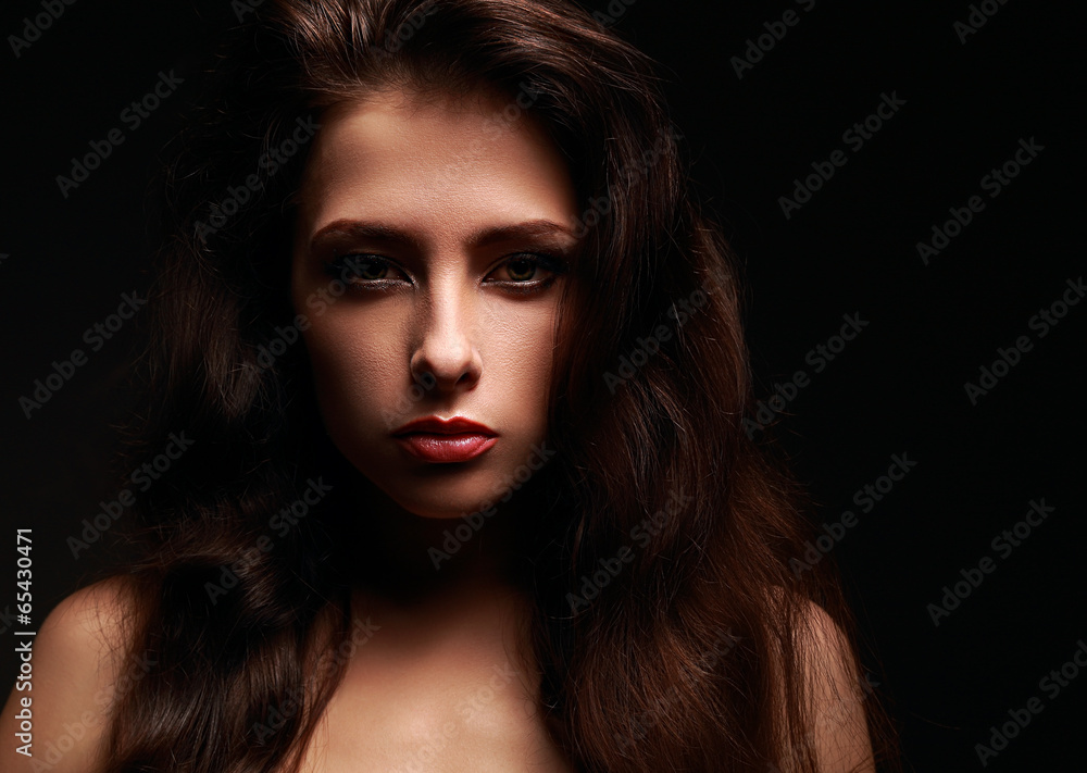 Beautiful makeup woman with long hair on black background