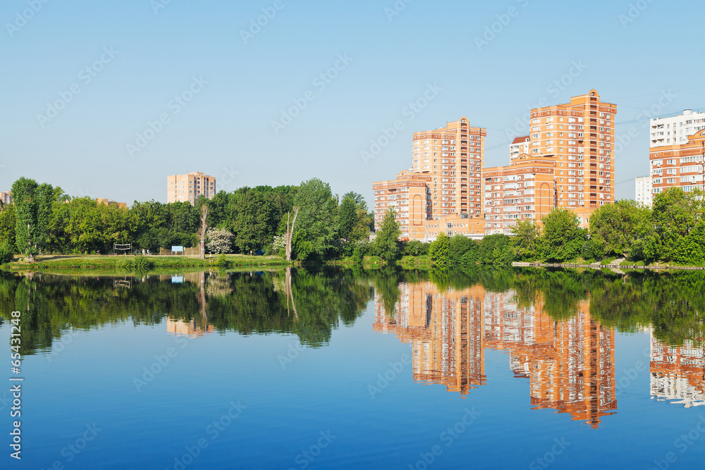 city pond with houses along the waterfront city pond with houses along the waterfront