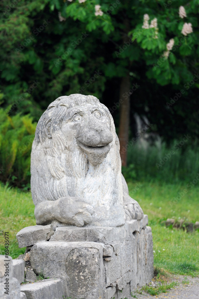 Stony chapped figure of lion at entrance to Olesko Castle