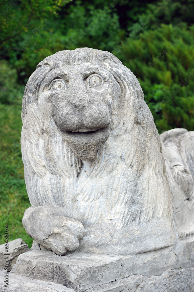 Stony chapped figure of lion at entrance to Olesko Castle
