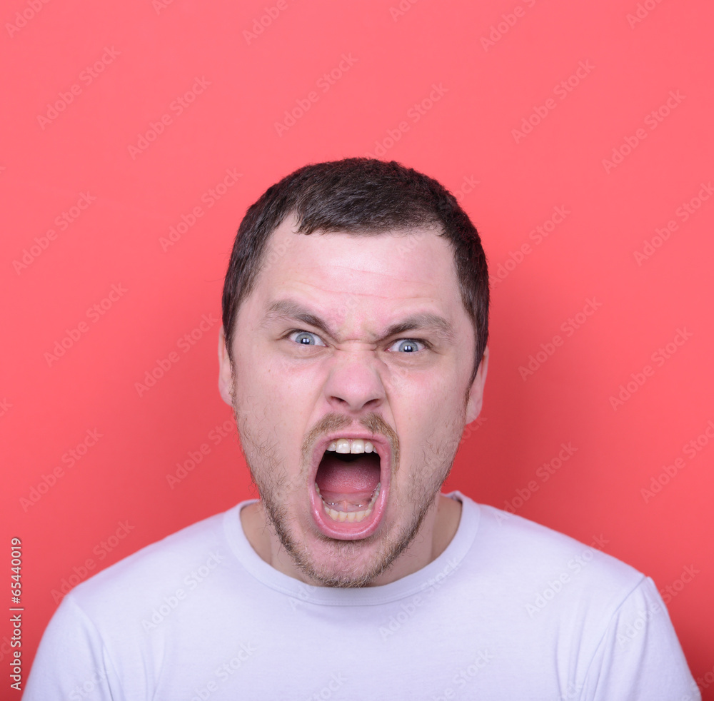 Portrait of angry man screaming against red background Portrait of angry man screaming against red background