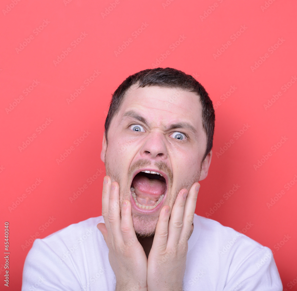 Portrait of angry man screaming against red background Portrait of angry man screaming against red background