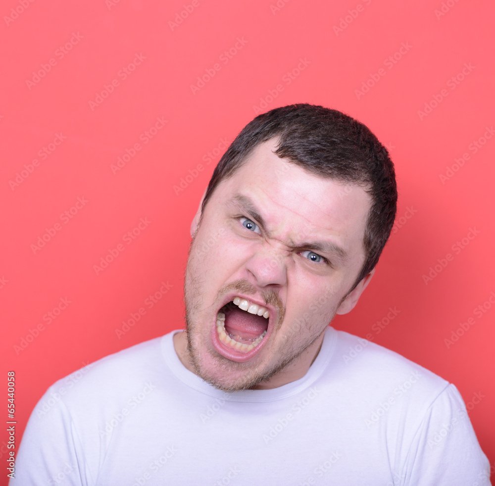 Portrait of angry man screaming against red background Portrait of angry man screaming against red background