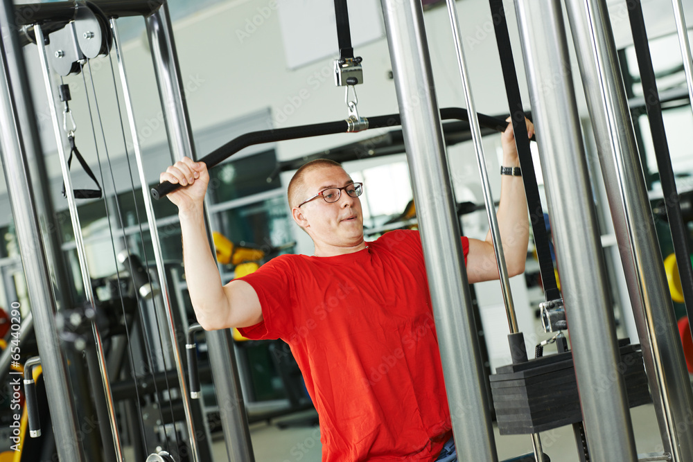 man doing back exercises at fitness gym man doing back exercises at fitness gym