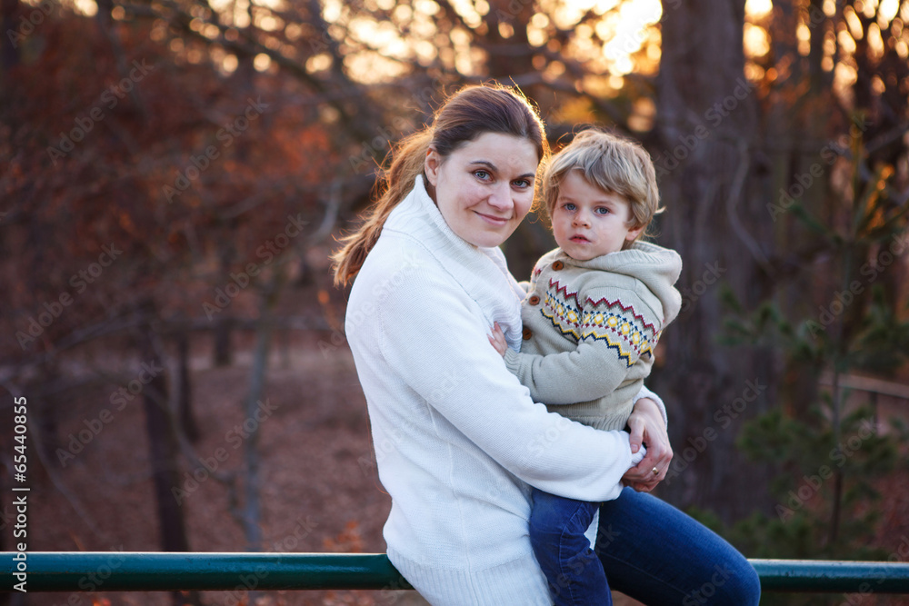 Mother and little son in park or forest, outdoors. Mother and little son in park or forest, outdoors.