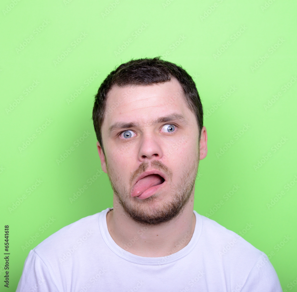 Fototapeta premium Portrait of man with funny face against green background
