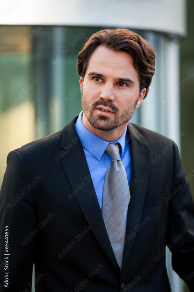 Businessman standing waiting for someone Businessman standing waiting for someone
