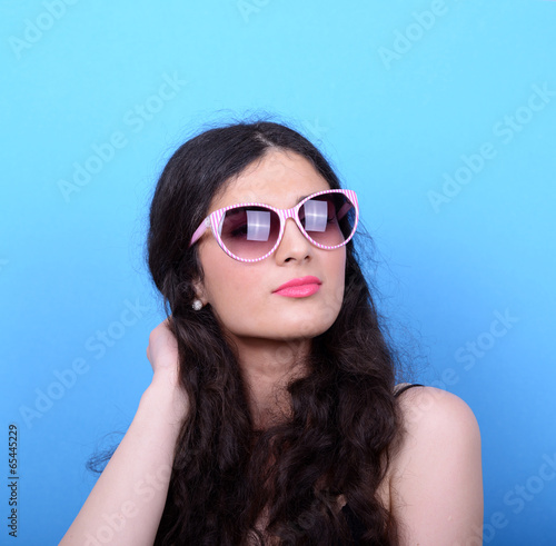 Wallpaper Mural Portrait of woman with retro glasses against blue background Torontodigital.ca