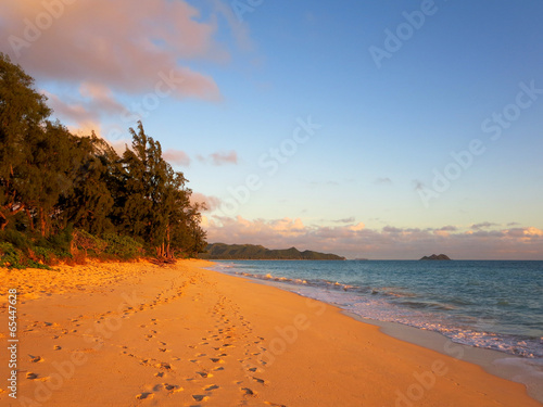 Gentle waves crash on Waimanalo Beach on Oahu, Hawaii at dawn photo