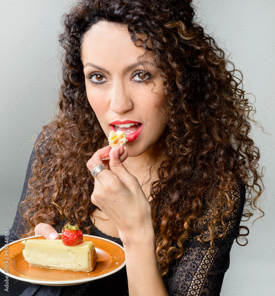 Beautiful woman eating cheese cake