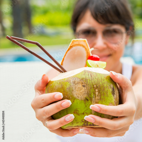 Young pretty woman with a coconut cocktail