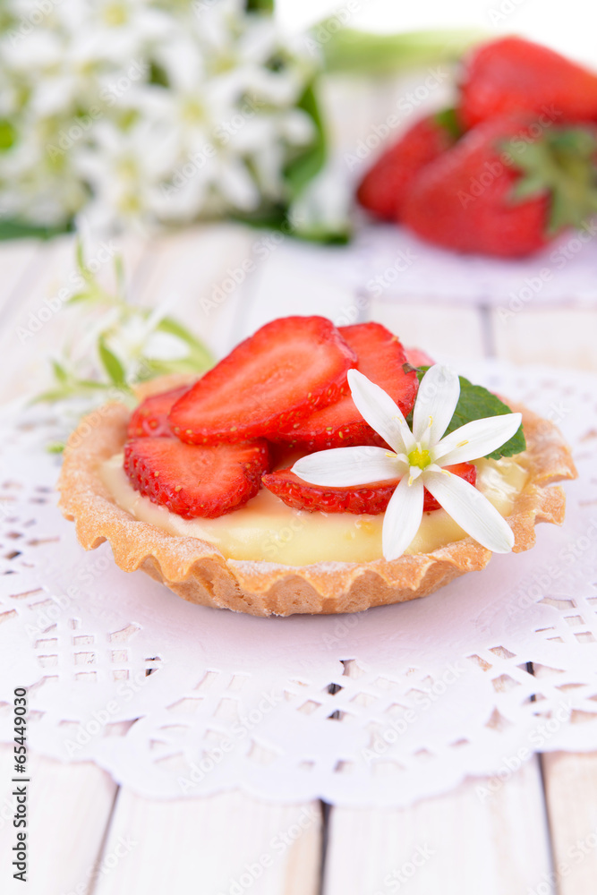 Tasty tartlet with strawberries on table close-up Tasty tartlet with strawberries on table close-up
