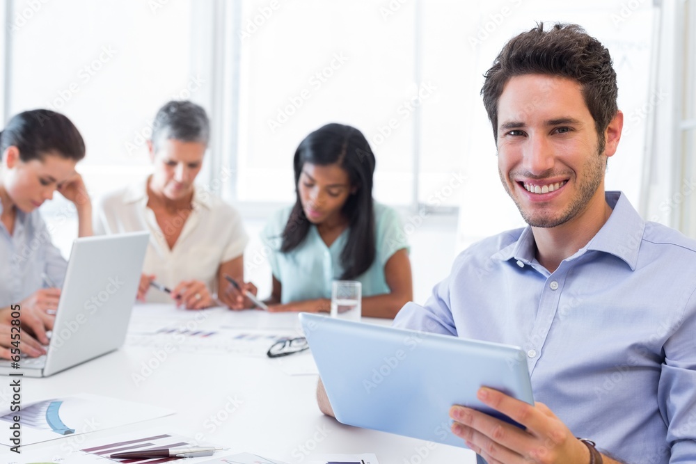 Attractive businessman using a tablet at work Attractive businessman using a tablet at work