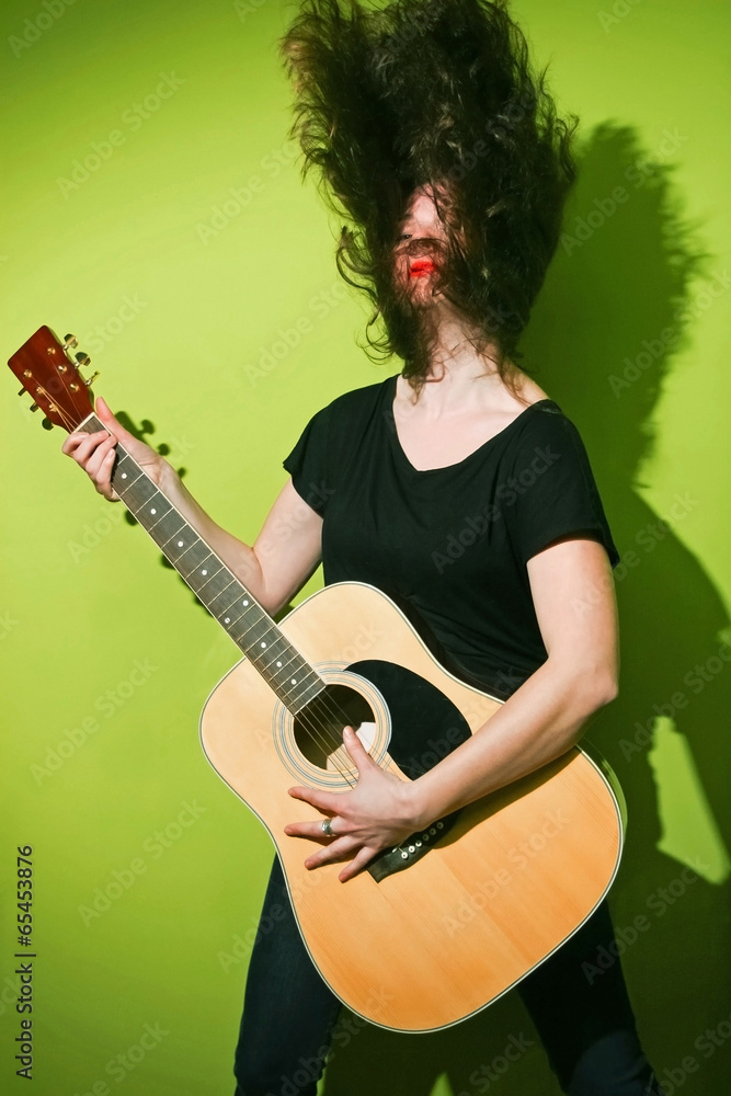 Obraz premium Rock woman with guitar shaking hair