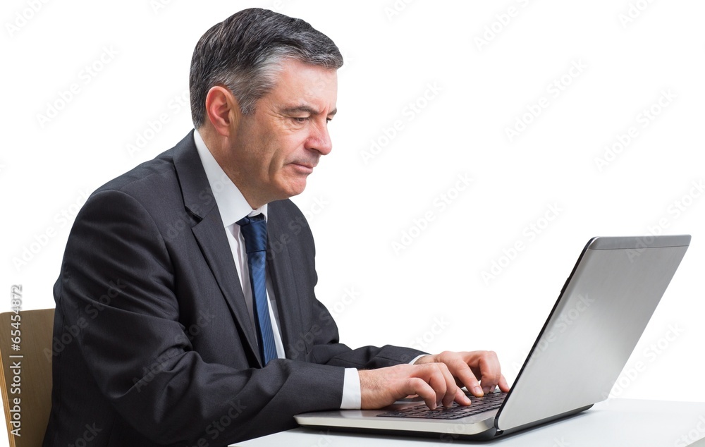 Mature businessman using his laptop Mature businessman using his laptop